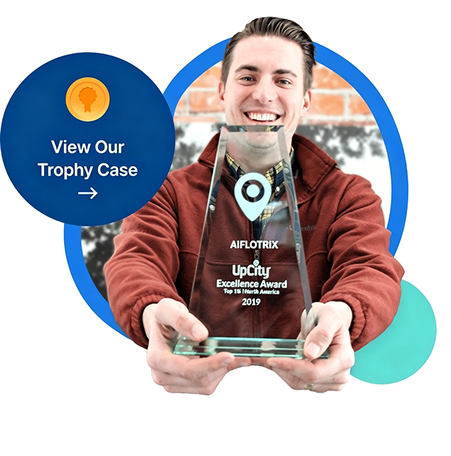 A smiling person holding a clear glass trophy with the text 'AIFLOTRIX UpCity Excellence Award Top 1% North America 2019'.